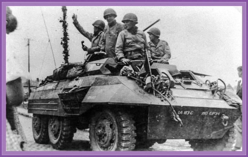 The inhabitants welcome an M20 armored personnel carrier of headquarters, 113th Cavalry Group during the liberation of Soignies, Belgium. September 12, 1944.