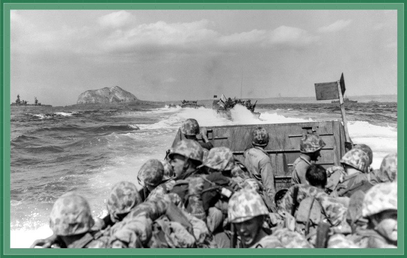 LCVP "Higgins Boats" carry US Marines toward the beach of Iwo Jima on February 19, 1945. Mount Suribachi can be seen as they approach.