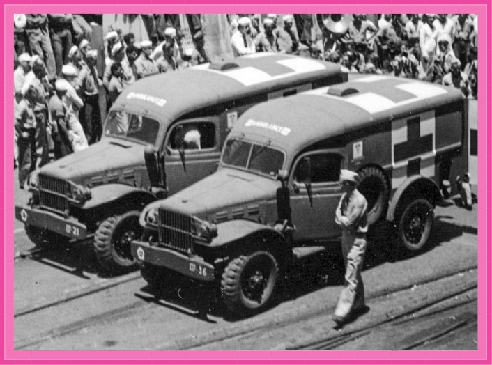 Two WC-54 Dodge Field Ambulances prepare to embark injured sailors onto the USS Intrepid at Pearl Harbor, Hawaii circa 1944-1945.