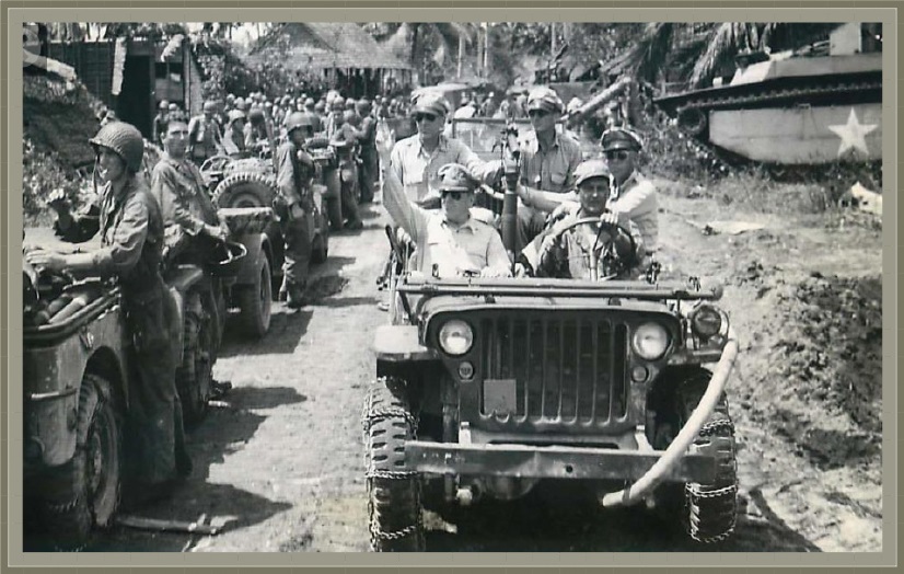 General Douglas MacArthur, who personally led his troops in the invasion of Leyte in 1944, waves a greeting to his men during an inspection a few hours after the landings.