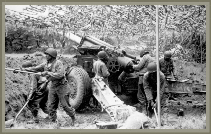 US African American soldiers from the 333rd Field Artillery Battalion set up a 155mm howitzer at the Battle of the Bulge in June 1944.